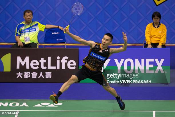 Malaysia's Lee Chong Wei hits a shot against China's Tian Houwei during their first round men's singles match at the Hong Kong Open badminton...