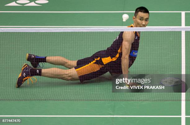 Malaysia's Lee Chong Wei watches his shot against China's Tian Houwei after he slipped during their first round men's singles match at the Hong Kong...