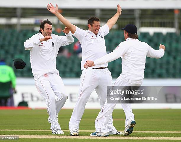 Tim Bresnan of England is congratulated on the wicket of Fidel Edwards of the West Indies by Graeme Swan and Graham Onions during day five of the...