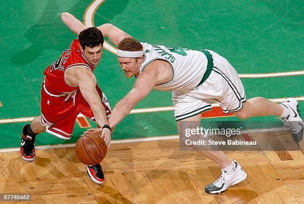 Kirk Hinrich of the Chicago Bulls and Brian Scalabrine of the Boston Celtics go after a loose ball in Game Seven of the Eastern Conference...