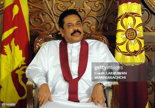 Sri Lankan President Mahinda Rajapaksa listens as his staff inform him that the war against the Tamil Tiger rebels had ended successfully, in Colombo...