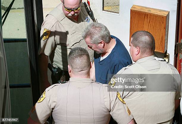 Former Bolingbrook, Illinois police officer Drew Peterson is escorted by correctional officiers from the Will County Courthouse after his arraignment...