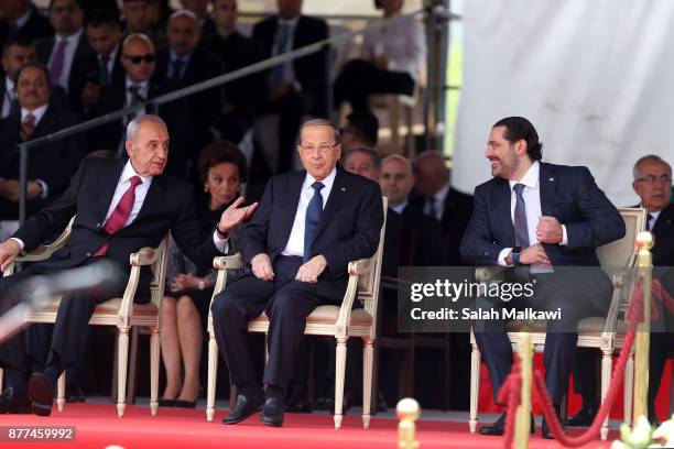 Lebanon's prime minister Saad Hariri sits next to Lebanese President Michel Aoun and speaker of parliament Nabih Berry the Independence Day ceremony...