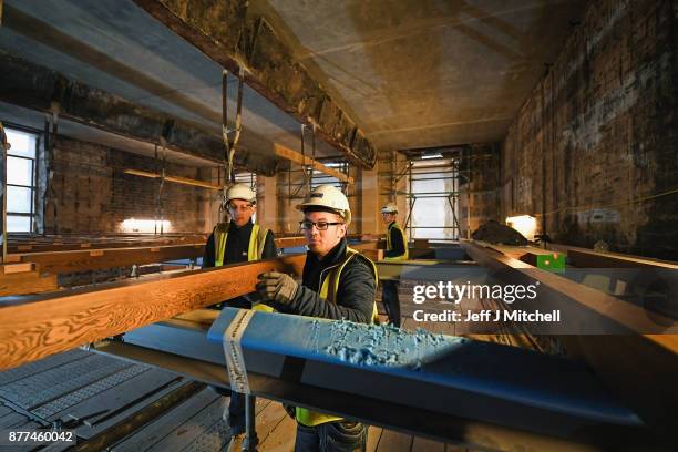 Specialist carpenters from Lawrence McIntosh install the floor to the bookstore above the Mackintosh Library on November 22, 2017 in Glasgow,...