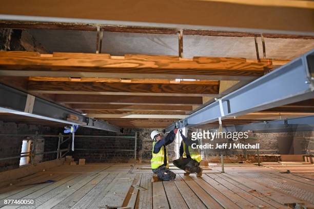 Specialist carpenters from Lawrence McIntosh work on a beam as they install the floor to the bookstore above the Mackintosh Library on November 22,...