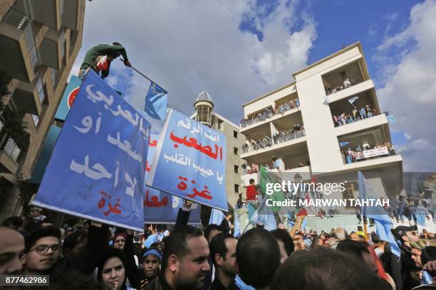 Supporters of Lebanese prime minister Saad Hariri wave the Lebanese flag alongside the Saudi and Future Movement flags as they gather at his home in...