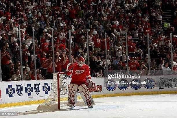 Chris Osgood of the Detroit Red Wings skates around the crease as the crowd chants his name in the backround during Game Seven of the Western...