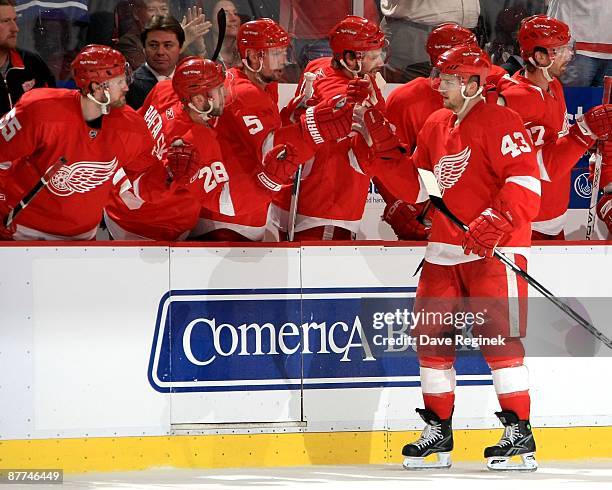 Darren Helm of the Detroit Red Wings gets congradulated by his teamates on the bench after scoring a goal during Game Seven of the Western Conference...