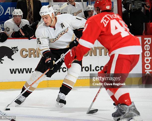 Ryan Getzlaf of the Anaheim Ducks skates with the puck as Henrik Zetterberg of the Detroit Red Wings tries to defend him during Game Seven of the...