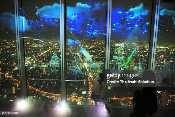 Visitors enjoy projection mapping and nightscape of Osaka as the City Light Fantasia begins at Aabeno Harukas on November 22, 2017 in Osaka, Japan....