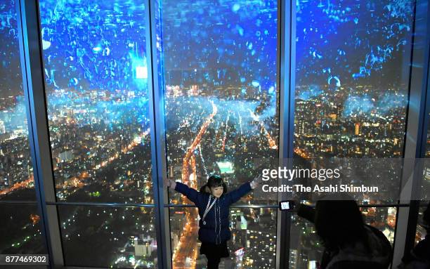 Visitors enjoy projection mapping and nightscape of Osaka as the City Light Fantasia begins at Aabeno Harukas on November 22, 2017 in Osaka, Japan....