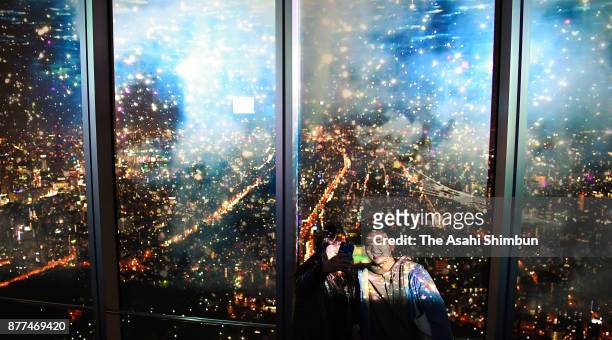 Visitors enjoy projection mapping and nightscape of Osaka as the City Light Fantasia begins at Aabeno Harukas on November 22, 2017 in Osaka, Japan....