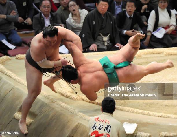 Sekiwake Yoshikaze pushes Mongolian yokozuna Hakuho out of the ring to win during day eleven of the Grand Sumo Kyushu Tournament at Fukuoka...