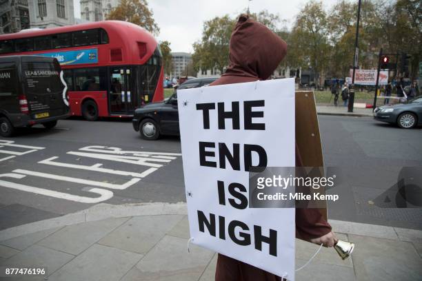 Demonstrator with a sandwich board reading The End Is Nigh protests in Westminster on Budget Day on 22nd November 2017 in London, England, United...