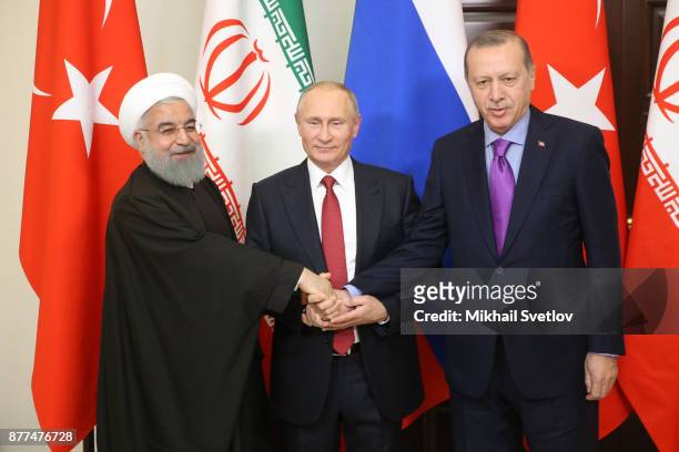 Russian President Vladimir Putin pose for a photo with Turkish President Recep Tayyip Erdogan and Iranian President Hassan Rouhani prior to their...