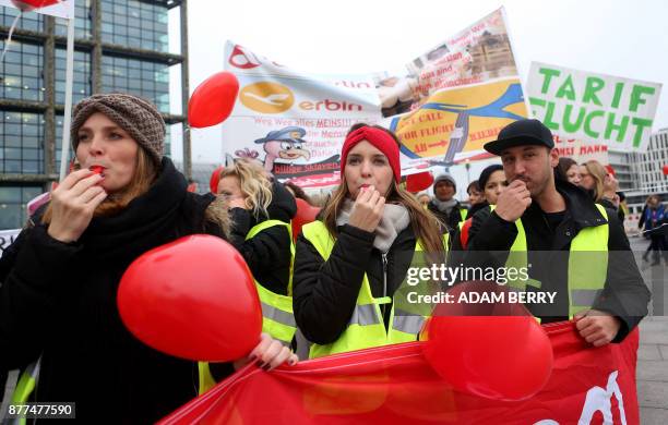 Employees of bankrupt airline Air Berlin hold balloons and banners during a demonstration against job losses and uncertainty over their fate under...