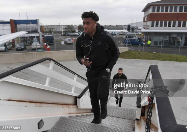 Alex Iwobi of Arsenal boards the plane at Luton Airport on November 22, 2017 in Luton, England.
