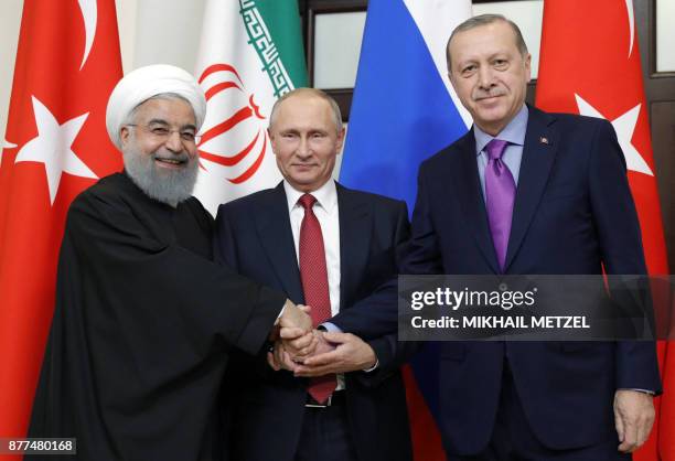 Russian President Vladimir Putin , Turkish President Recep Tayyip Erdogan and Iranian President Hassan Rouhani pose during a trilateral meeting on...