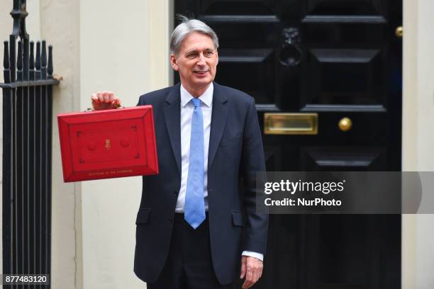 Britain's Chancellor of the Exchequer Philip Hammond holds the red case as he departs 11 Downing Street to deliver his Budget to Parliament, London...