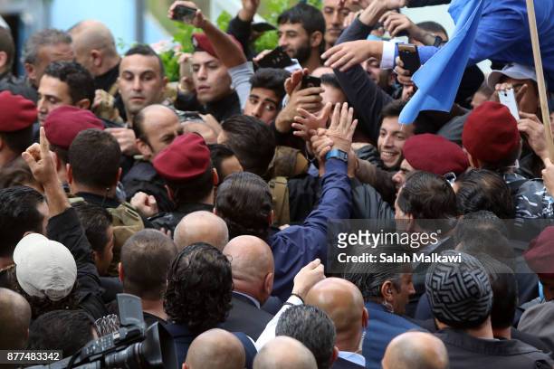 Lebanon's Prime Minister Saad Hariri is greeted by people as he makes a public appearance at his home "Beit al-Wasat" November 22, 2017 in Beirut,...