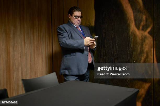 Ratko Mladic's lawyer Dragan Ivetic eyes his smartphone as Ratko Mladic's son Darko Mladic gives a press conference with the defenders on November...