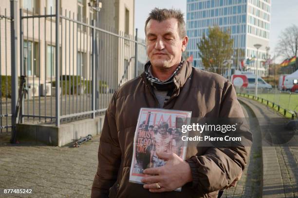 Bosnian muslim Fikret Alic stands outside the tribunal with his iconic photo taken in a concentration camp in Bosnia, on November 22, 2017 in The...