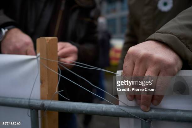 Bosnian Muslims hang a banner on a fence outside the International Criminal Tribunal for the former Yugoslavia on November 22, 2017 in The Hague, The...