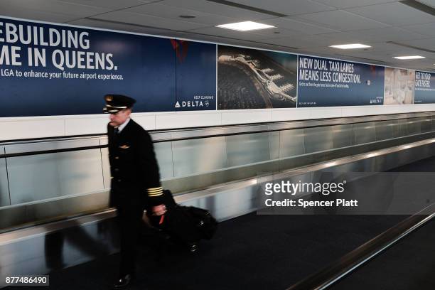 Pilot walks through LaGuardia Airport on the day before Thanksgiving, the nation's busiest travel day on November 22, 2017 in New York City....
