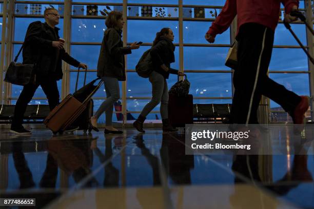 Travelers wait in line before going through Transportation Security Administration screening at Ronald Reagan National Airport in Washington, D.C.,...