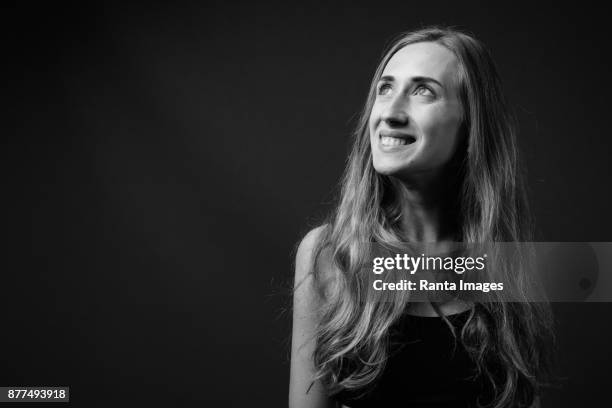 young beautiful woman against black background - monochrome 700063863 stock pictures, royalty-free photos & images