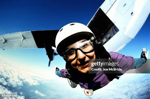 skydiver flying in mid-air, plane in background, close-up - skydiving bildbanksfoton och bilder