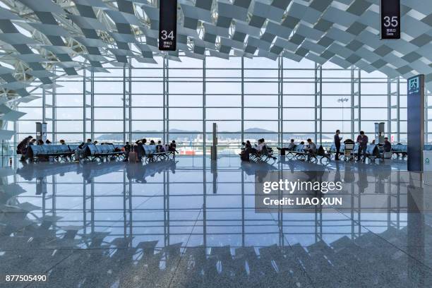 departure area of shenzen airport terminal - airport terminal interior stock-fotos und bilder