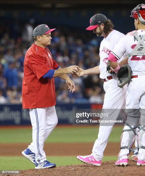 Jason Grilli of the Toronto Blue Jays exits the game as he is relieved by manager John Gibbons in the seventh inning during MLB game action against...