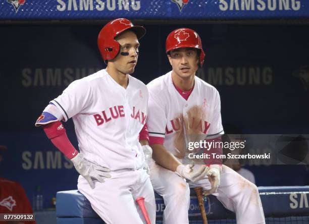 Ryan Goins of the Toronto Blue Jays talks to Darwin Barney in front of the dugout during a break in the action in the fourth inning during MLB game...