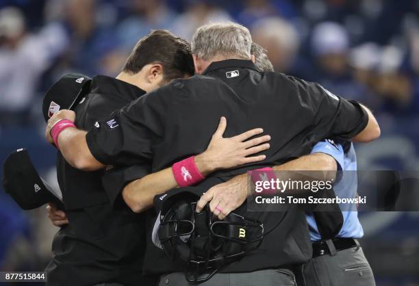 Second base umpire John Tumpane and third base umpire Ted Barrett and home plate umpire Angel Hernandez and first base umpire Lance Barksdale gather...