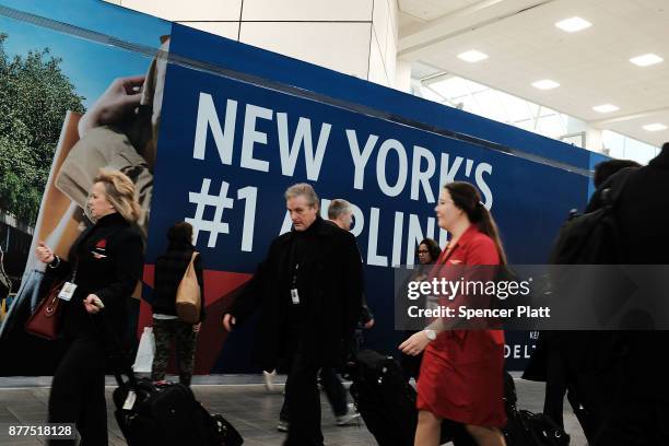 People walk through LaGuardia Airport on the day before Thanksgiving, the nation's busiest travel day on November 22, 2017 in New York, New York....