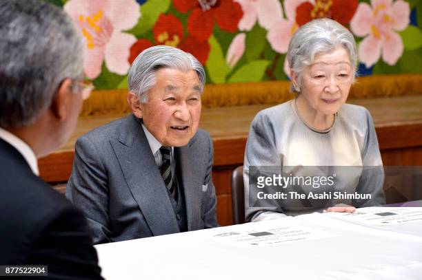 Emperor Akihito and Empress Michiko talk with residents who are suffering volcano activities at Kuchinoerabujima Island on November 16, 2017 in...