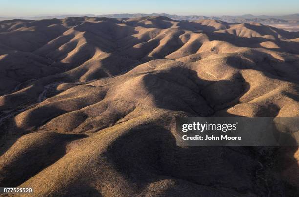 Customs and Border Protection pilots fly over the Big Bend area of west Texas on November 22, 2017 near Van Horn, Texas. Federal agents are searching...