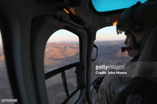 Customs and Border Protection pilots fly over the Big Bend sector of west Texas on November 22, 2017 near Van Horn, Texas. Federal agents are...