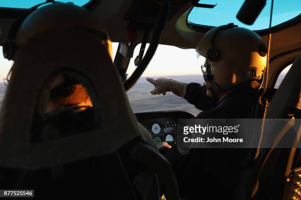 Customs and Border Protection pilots fly over the Big Bend sector of west Texas on November 22, 2017 near Van Horn, Texas. Federal agents are...