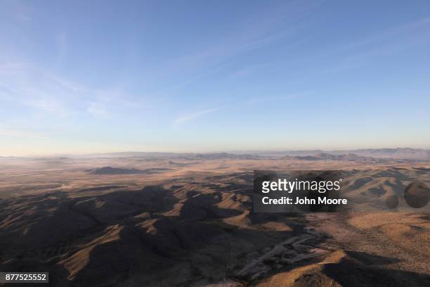 Customs and Border Protection pilots fly over the Big Bend area of west Texas on November 22, 2017 near Van Horn, Texas. Federal agents are searching...