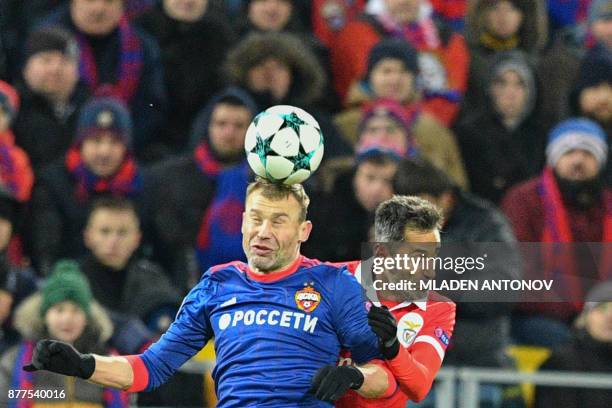 Moscow's defender from Russia Vasily Berezutskiy and Benfica's forward from Brazil Jonas vie for the ball during the UEFA Champions League Group A...