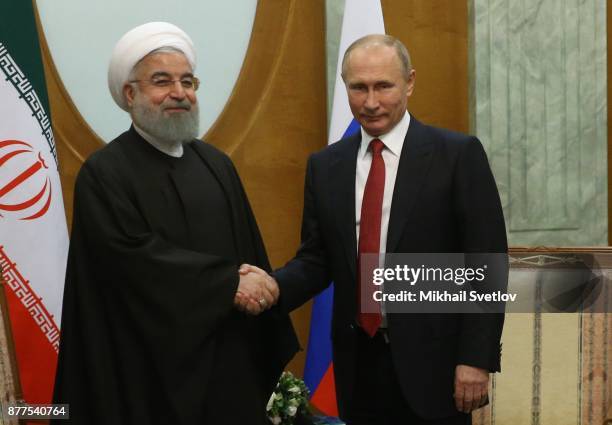 Russian President Vladimir Putin talks to Iranian President Hassan Rouhani during their meeting at the Black Sea resort of Sochi on November 22, 2017...
