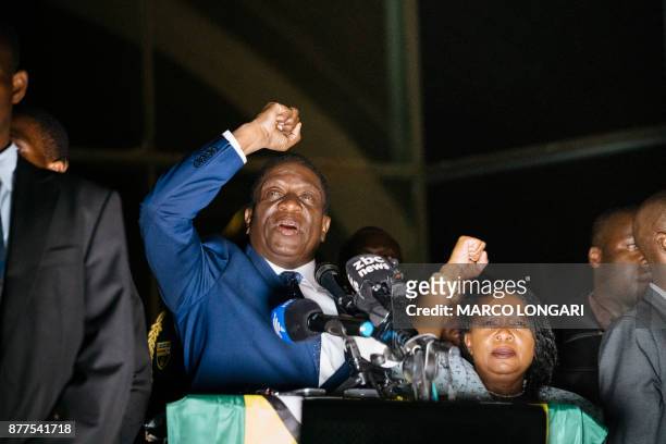 Zimbabwe's incoming president Emmerson Mnangagwa speaks to supporters flanked by his wife Auxilia at Zimbabwe's ruling Zanu-PF party headquarters in...