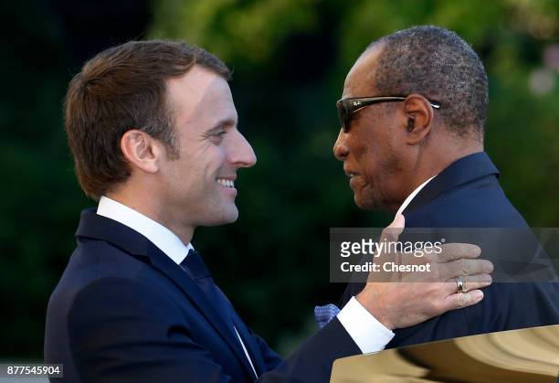 French President Emmanuel Macron welcomes Guinea's President and President of the African Union Alpha Conde prior to their meeting at the Elysee...