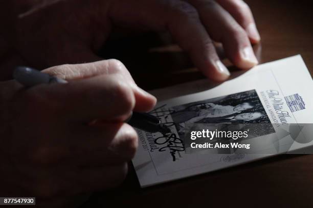 Vice President Mike Pence signs a card for Marine Corps veteran Liam Dwyer at the USO Warrior and Family Center November 22, 2017 in Bethesda,...