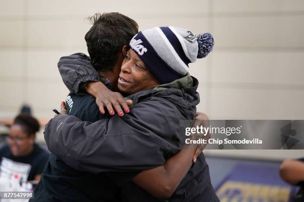 Bennett Career Institute Director of Ourtreach Services Brenda Arnold gets a hug from Debra O'Neal after she received a free manicure during the...