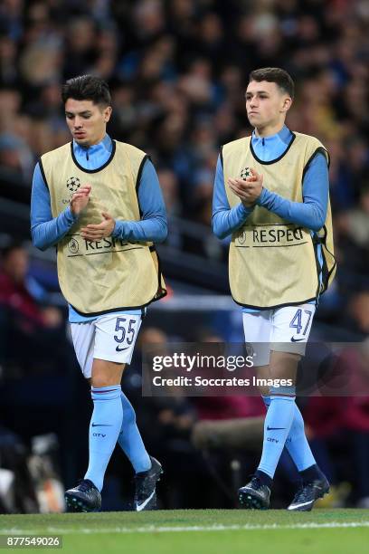 Brahim Diaz of Manchester City and teammate Phil Foden warm up on the sideline during the UEFA Champions League match between Manchester City v...