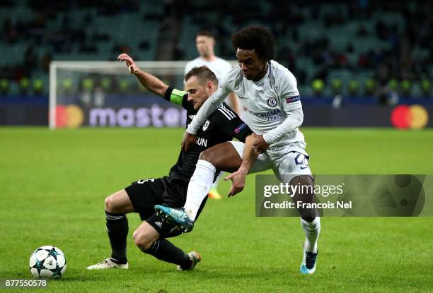 Maksim Medvedev of Qarabag FK and Willian of Chelsea react during the UEFA Champions League group C match between Qarabag FK and Chelsea FC at Baki...