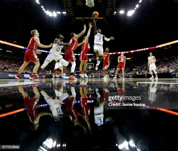 Aaron Holiday of the UCLA Bruins drives toward the basket during the National Collegiate Basketball Hall Of Fame Classic consolation game against the...